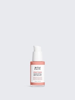 Skincare serum bottle with pink cap and label on a light gray background