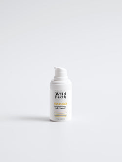 White eye cream bottle labeled 'Wild Earth' on a white background
