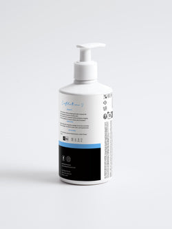 White bottle with a pump on a light gray background